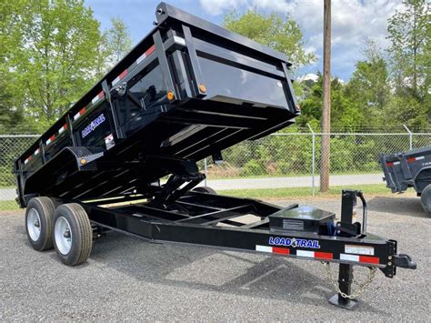 A dump trailer is a hauling trailer with a hydraulic lift that allows the trailer bed to be raised from its frame in order to haul and unload heavy materials easily. . Used dump trailers for sale near me